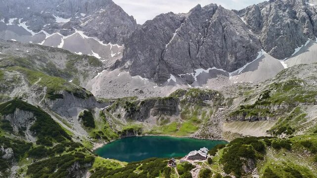 Aerial drone view of the Alps and the green Drachensee on a sunny summer day. 