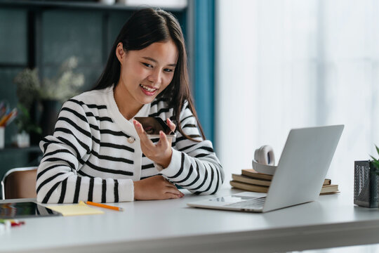 Asian woman using voice assistant AI learning on smartphone - Powered by Adobe