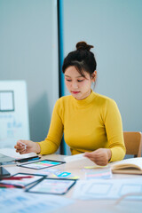 Portrait of Young creative startup woman at workplace