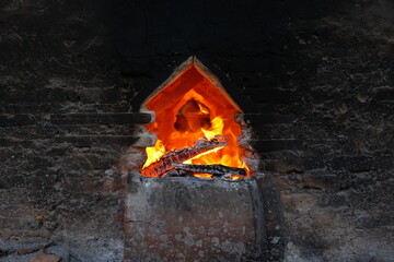 Burning wood in a brick kiln pit