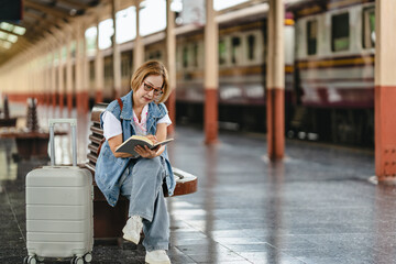 Mature woman awaiting her journey at train station platform