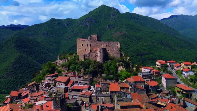 Aerial view of the ruins of an ancient castle, a medieval village on a hill near the Neva River valley and built for defensive purposes, history. Castelvecchio di Rocca Barbena Savona Italy 22.09.2025
