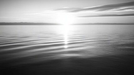 Fototapeta premium Serene sunset over calm water, sun's reflection shimmering on gentle waves, tranquil horizon