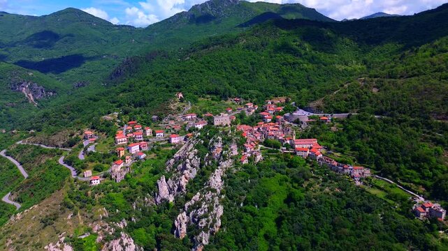 Aerial view of the ruins of an ancient castle, a medieval village on a hill near the Neva River valley and built for defensive purposes, history. Castelvecchio di Rocca Barbena Savona Italy 22.09.2025