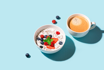 Chia bowl with yogurt and berries on blue