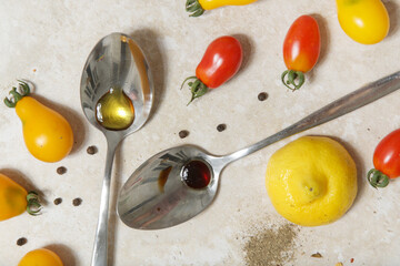 Summer salad ingredients - Freshly harvested cherry tomatoes, spoon of vinegar and olive oil, salt...