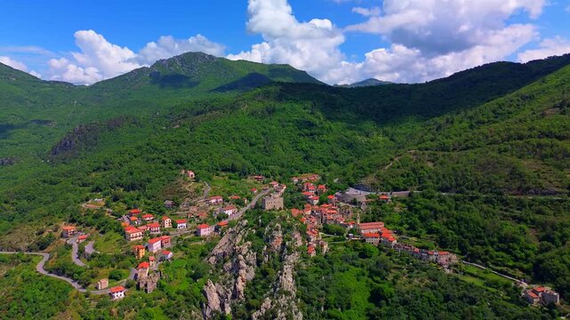 Aerial view of the ruins of an ancient castle, a medieval village on a hill near the Neva River valley and built for defensive purposes, history. Castelvecchio di Rocca Barbena Savona Italy 01.09.2025