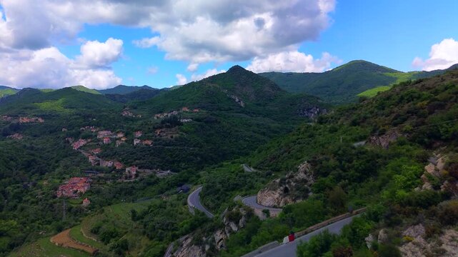 Drone view of serpentine asphalt road in mountainous area in Italian Alps. cars are going on a trip. Green planet. Tourism. Transport. Dangerous road. Italy Bergamo 20.08.2025