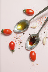 Summer salad ingredients - Freshly harvested cherry tomatoes, spoon of vinegar and olive oil, salt and pepper
