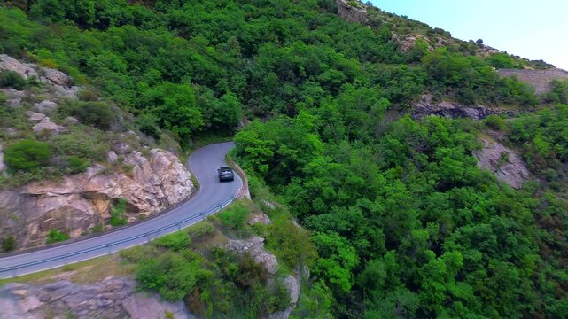 Drone view of serpentine asphalt road in mountainous area in Italian Alps. cars are going on a trip. Green planet. Tourism. Transport. Dangerous road. Italy Bergamo 20.08.2025