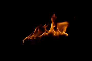 Flickering Flames on a Dark Background Creating Warm Atmosphere