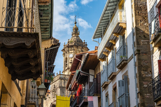 Fototapeta Typical wooden balconies with flowers in the streets of the historic center of the picturesque village of Hondarribia, Basque Country.