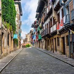Typical cobbled streets with wooden balconies with flowers in the picturesque village of...