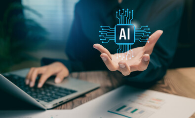 Artificial intelligence technology concept. Businessman using laptop with virtual AI chip icon to represent machine learning innovation.