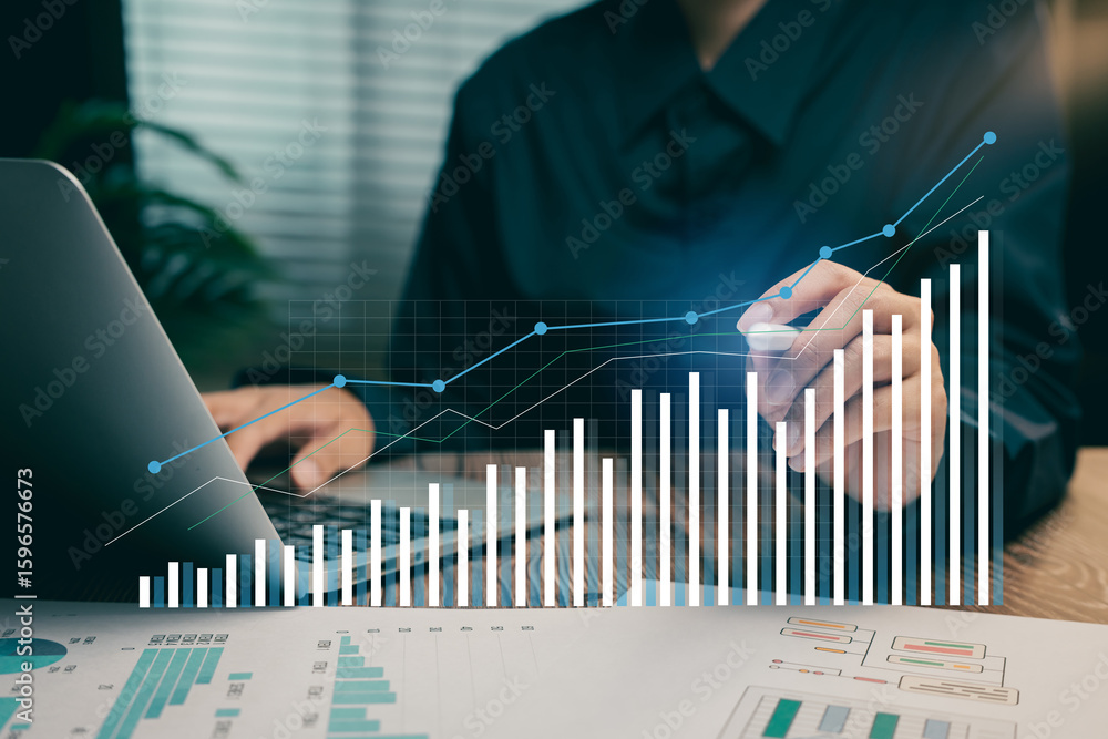 Poster business data analytics concept. hand using pen and laptop with futuristic bar charts and financial 