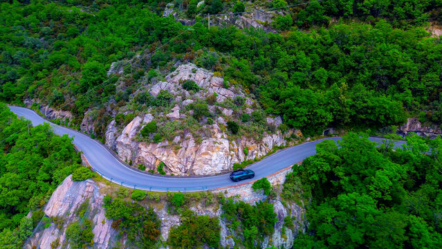 Drone view of serpentine asphalt road in mountainous area in Italian Alps. cars are going on a trip. Green planet. Tourism. Transport. Dangerous road. Italy Bergamo 20.08.2025