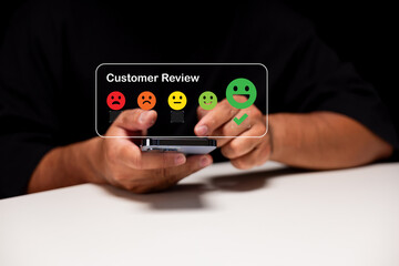 A person interacts with a smartphone, selecting a positive customer review emoji among a range of emoticons indicating satisfaction levels.