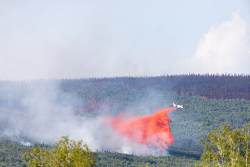 Dash 8 dropping fire retardant.