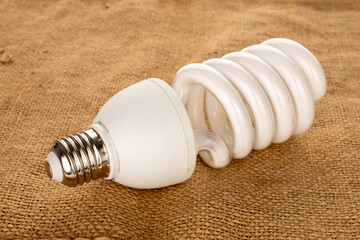 One LED lamp on jute cloth, macro.