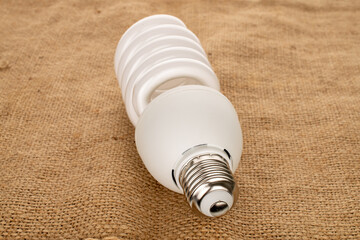 One LED lamp on jute cloth, macro.