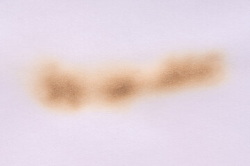 Paper burn black  stain. Round paper burn mark close up. burns borders paper close up