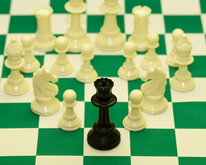 Close up the queen chess piece standing with chessboard on dark background. Leader, influencer,...