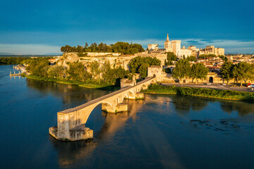 Naklejka premium Beautiful view of Avignon with famous bridge Saint-Benezet, medieval architecture along the Rhone River in Avignon, France. The Pont Saint Benezet and the Papal palace in Avignon, South France.