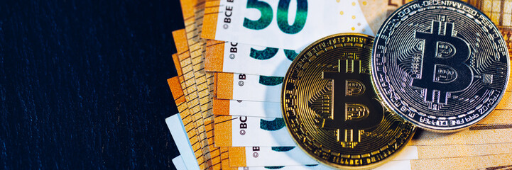 Golden bitcoin over Euro money. Bitcoin cryptocurrency. Crypto currency concept. Bitcoin with euro bills. Bitcoins stacked on euro banknotes.