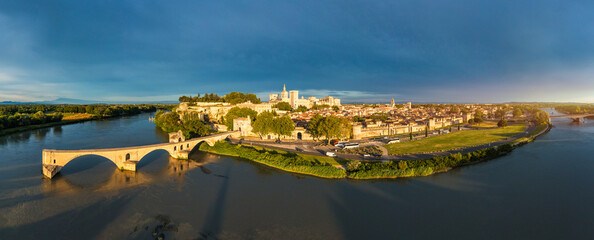 Beautiful view of Avignon with famous bridge Saint-Benezet, medieval architecture along the Rhone River in Avignon, France. The Pont Saint Benezet and the Papal palace in Avignon, South France.