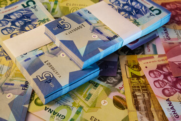 mixed Ghanaian cedi notes bundles denominations spread entirely on surface screen. Colorful Paper money currency as full screen wallpaper background