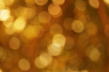 Warm bokeh light illuminating a serene and inviting golden hue background, evoking feelings of