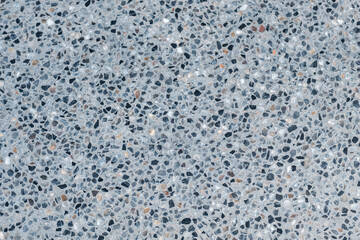 A grey stone floor with many small stones on it