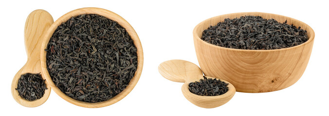 Dry black tea leaves in wooden bowl and spoon isolated on white background. Top view. Flat lay