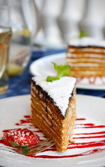 Closeup of traditional Ukrainian honey cake with 14 layers, topped with chocolate glaze and...