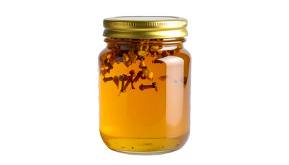 Honey infusion with cloves and pistachios in a glass jar with a gold lid