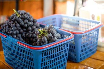 Fresh Grapes in Blue Baskets at the Market