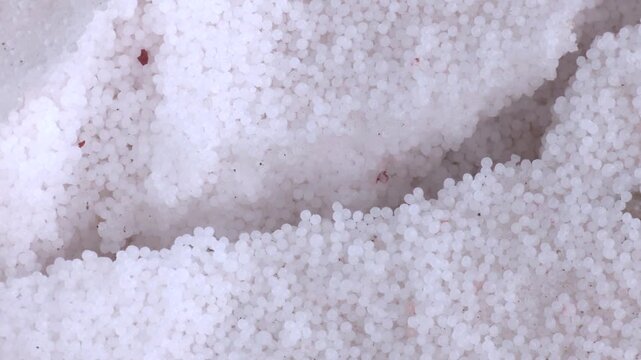 Organic chemical fertilizers in production plant warehouse. Chemical fertilizer piles in the warehouse are waiting for the delivery of the type of bulk.