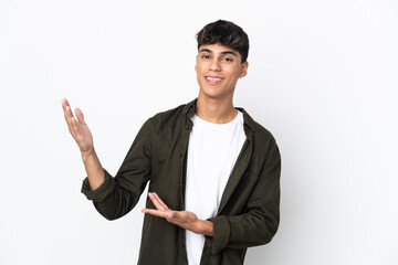 Young man over isolated white background extending hands to the side for inviting to come