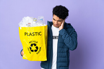 Young Venezuelan man holding a bag full of plastic bottles frustrated and covering ears