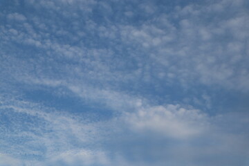 A beautiful blue sky with wispy clouds, perfect for a calming and serene atmosphere.