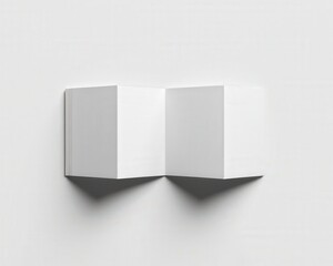 Fototapeta premium Minimal closed trifold brochure mockup casting long sharp geometric shadow on pure white background under light. Ideal flyer template, mock-up for branding and ads.