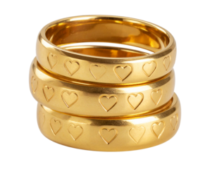 “Stacked Gold Wedding Rings with Engraved Heart Design, isolated on transparent background”