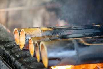 Delicious Food Being Grilled in Bamboo Tubes