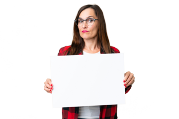 Middle age woman over isolated chroma key background holding an empty placard