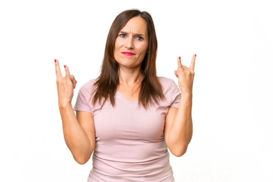 Middle-aged caucasian woman over isolated background making horn gesture