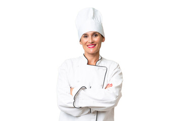 Middle-aged chef woman over isolated background keeping the arms crossed in frontal position