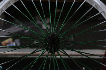 Close-up View of a Bicycle Wheel Showing Details of Spokes and Hub with Green Accents