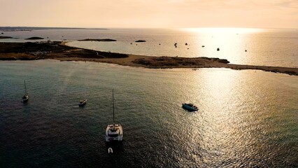 Aerial view of sunset in the beautiful beach of Ses Illetes, in the Spanish Mediterranean island of Formentera.