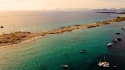 Aerial view of sunset in the beautiful beach of Ses Illetes, in the Spanish Mediterranean island of...