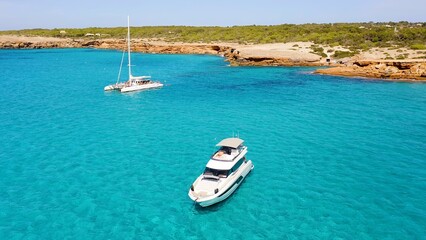 Aerial view of anchorage in the turquoise waters of Cala Saona, in the Spanish Mediterranean island of Formentera. 